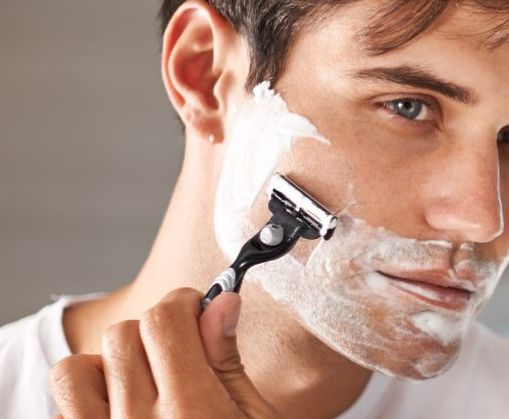 How To Shave Sensitive Skin: A Complete Guide. Close up of man shaving his face