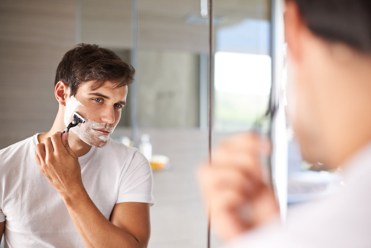 Man shaving painlessly using shave cream