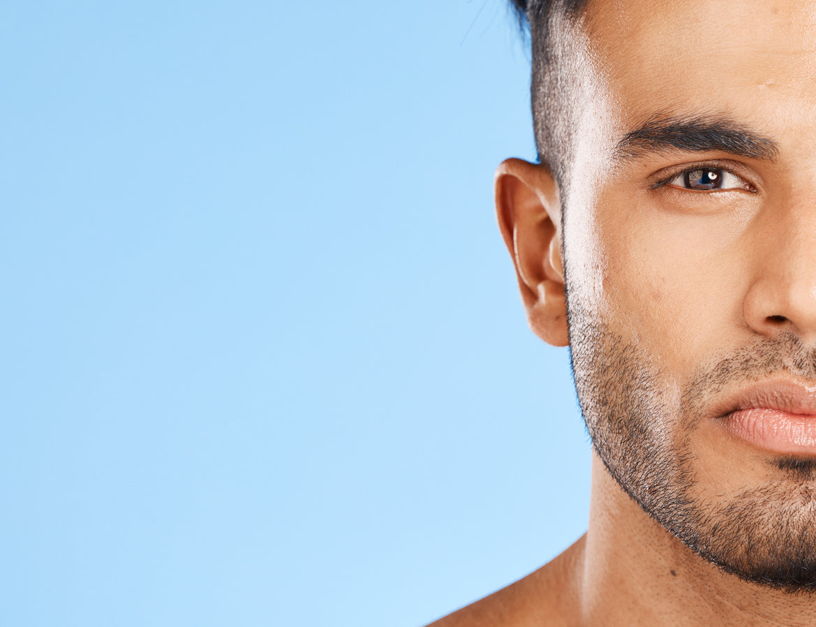 7 Skincare Tips To Stop Signs Of Aging, According To A Plastic Surgeon. Half face of handsome man with perfect face