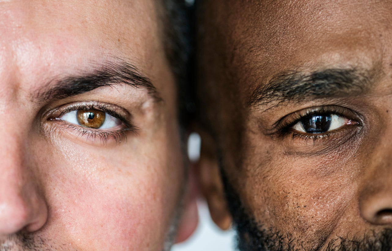 Do Men Really Need Anti-Aging Skincare? Here’s Why It Pays Off. Close up of eyes of two different ethnic men