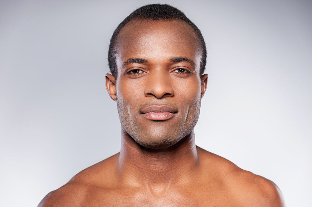 How to Get an Even Tone: Tips for Clear, Radiant Skin Without a Complicated Routine. Close up of handsome young black man with glowing even skin tone