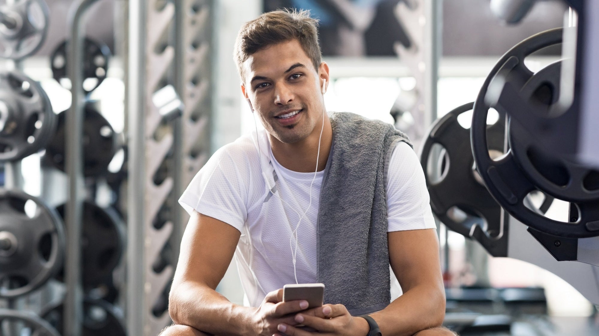 How to Avoid ‘Gym Skin’ - Preventing Breakouts and Irritation After Exercise. Handsome young man sitting in gym after workout