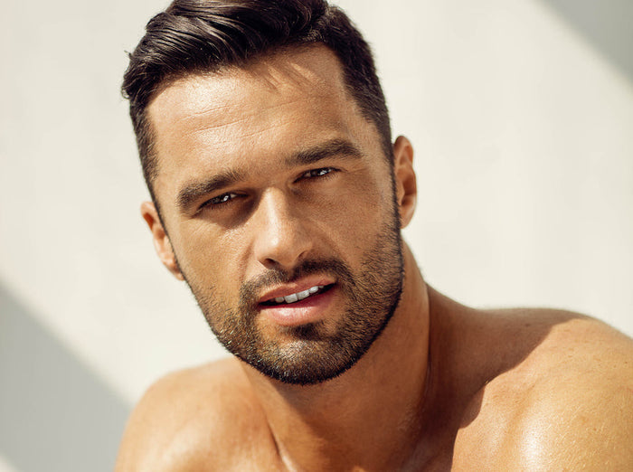 Alpha Hydroxy Acids: Younger, Brighter Skin with AHAs. Image of handsome young man in the light