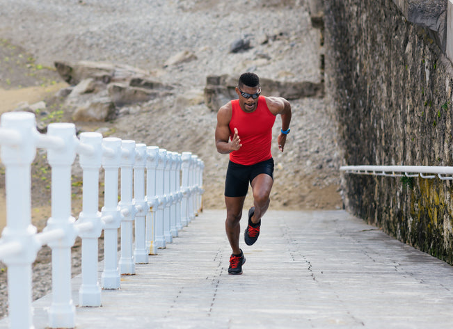 Which Supplements Are Best for Black Men? Black athlete running up slope by the beach