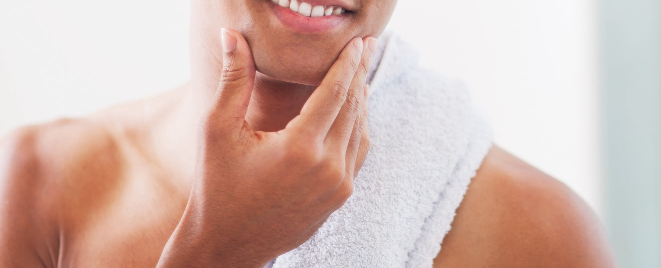 How to Prep Your Skin for the Perfect Shave. Man stroking his smooth shaven chin