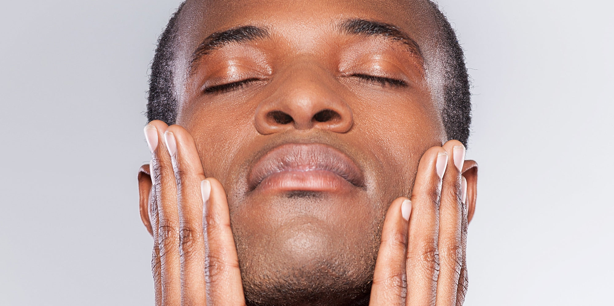 DARK SPOTS AND HYPER-PIGMENTATION. Black man smiling with beautiful clear skin