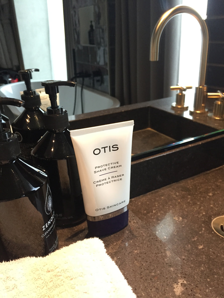 Tube of OTIS Protective Shave Cream on granite sink with copper taps